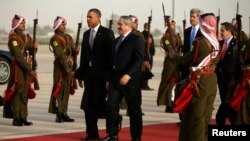 President Barack Obama walks with Jordanian Foreign Minister Nasser Judeh, right, upon his arrival at Queen Alia International Airport in Amman, Jordan, March 22, 2013. 