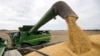 FILE -Soybeans are offloaded from a combine during the harvest in Brownsburg, Indiana, Sept. 21, 2018. Soybeans are one of the U.S. farm products China put tariffs on.