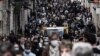 People walk in a crowded shopping street in Bordeaux, as cafes, restaurants and other businesses in France reopened after closures during the coronavirus pandemic. 