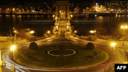 FILE - A picture taken on March 31, 2012 shows the Adam Clark square of Budapest and the oldest Hungarian bridge 'The Chain Bridge' after the city switched off its lights to mark the annual Earth Hour event. 