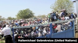 Civilians crush up against the gates of the UNMISS compound in Bor, Jonglei state, days after South Sudan erupted in violence in December 2013.