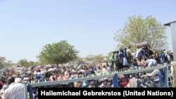 Civilians crush up against the gates of the UNMISS compound in Bor, Jonglei state, days after South Sudan erupted in violence in December 2013.