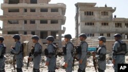 Afghan policemen stand in line near Kabul airport, June 10, 2013. Nearly 15 percent of so-called honor killings and sexual assaults in Afghanistan are committed by police, according to an independent human rights commission. 