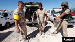 A fighter with Libyan forces allied with the U.N.-backed government holds an explosive belt left behind by Islamic State militants near the eastern frontline, in Sirte, Libya, Oct. 20, 2016. 