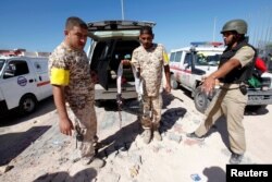 A fighter with Libyan forces allied with the U.N.-backed government holds an explosive belt left behind by Islamic State militants near the eastern frontline, in Sirte, Libya, Oct. 20, 2016.