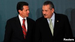 FILE - Mexico's President-elect Enrique Pena Nieto (L) and Congressman Manlio Fabio Beltrones attend a meeting with newly elected senators and lawmakers of the Institutional Revoluntionary Party (PRI) in Mexico City, Aug. 9, 2012. 