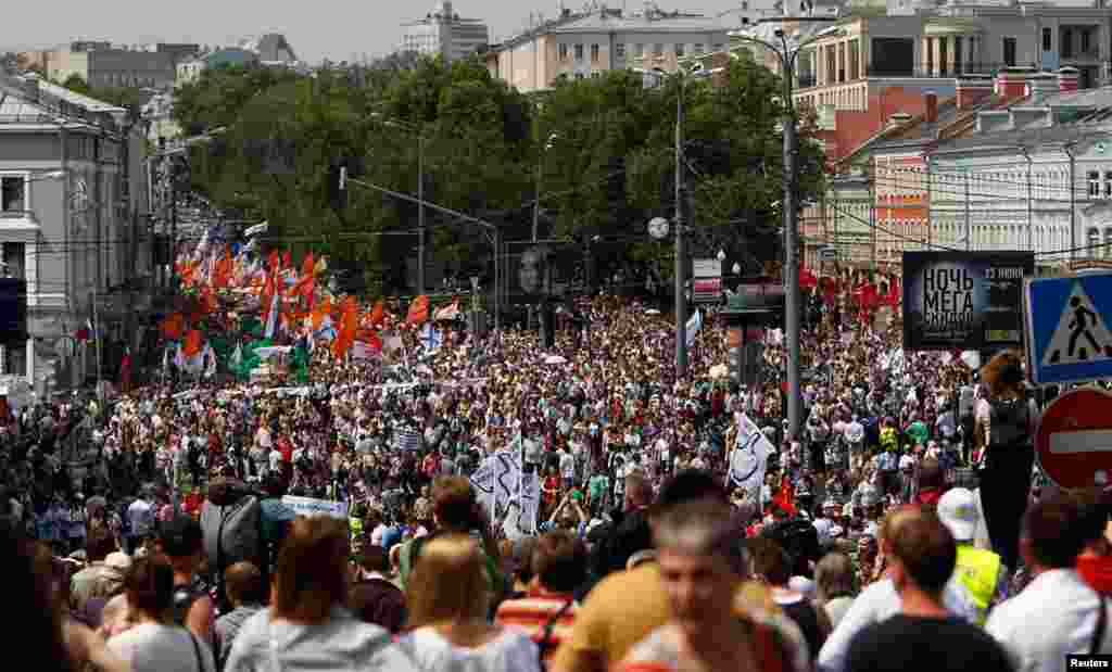 Participants march with flags and placards in Moscow.