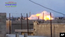 FILE - Smoke rising after a Russian airstrike hit buildings in the town of Latamna in the area of Hama in Eastern Syria, Oct. 7, 2015.