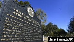 Old Plateau Cemetery, the final resting place for many who spent their lives in Africatown, stands in need of upkeep near Mobile, Ala. Many of the survivors of the slave ship Clotilda's voyage are buried here among the trees. (AP Photo/Julie Bennett)