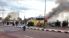 Security officials and onlookers are seen at the site of a tourist bus blast in the Egyptian south Sinai resort town of Taba Feb. 16, 2014.