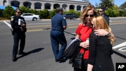 Jessica Parks, right, hugs Tina White outside the Chabad of Poway synagogue, April 27, 2019, in Poway, Calif., after a shooting occurred inside. At least one person was killed. 