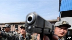 Chinese soldiers practice with their pistols at an undisclosed training camp in central China's Henan province (FILE)