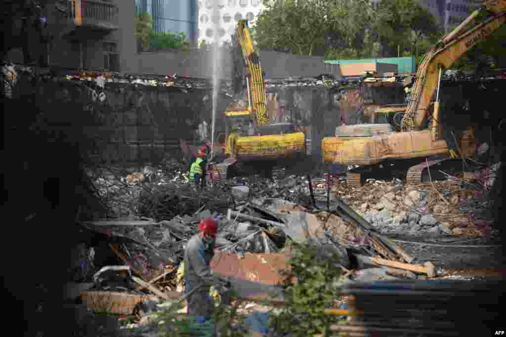 Workers demolish the former US embassy in Beijing 20 years after it was attacked by Chinese protestors on May 8, 1999.