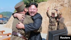 FILE - North Korean leader Kim Jong Un reacts with scientists and technicians of the DPRK Academy of Defense Science after the test-launch of the intercontinental ballistic missile Hwasong-14 in this undated photo released by North Korea's Korean Central News Agency.
