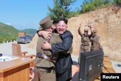 North Korean leader Kim Jong Un reacts with scientists and technicians of the DPRK Academy of Defence Science after the test-launch of the intercontinental ballistic missile Hwasong-14 in this undated photo released by North Korea.