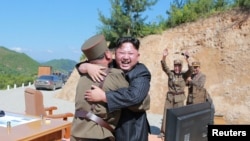 北韓領導人金正恩在洲際彈道導彈“哈桑十四號”測試發射成功後，與技術人員擁抱(2017年7月5日)