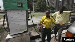 A man buys fuel at a petrol station in Lagos, Nigeria, April 24, 2012. 