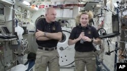 In this image made from video provided by NASA, astronaut Kate Rubins (R) speaks during an interview aboard the International Space Station, July 13, 2016.