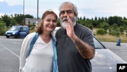 FILE - Mehmet Altan, a Turkish newspaper columnist and academic, and his wife Umit Altan, speak to the media after being released from the prison in Silivri, near Istanbul, June 27, 2018. A court has released Altan from prison, pending an appeal of his conviction and life sentence for alleged involvement in Turkey's 2016 failed coup attempt.