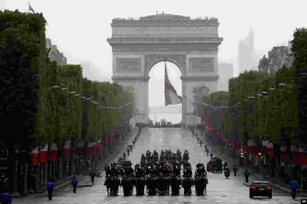 French President Emmanuel Macron's convoy drives up the Champs Elysees to mark Victory Day at the Arc de Triomphe in Paris.