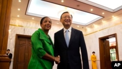 FILE - U.S. National Security Advisor Susan Rice, left, shakes hands with Chinese State Councilor Yang Jiechi at the Diaoyutai State Guesthouse in Beijing, China, Aug. 28, 2015.