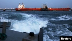 FILE PHOTO - An oil tanker is docked while oil is pumped into it at the ships terminal of PDVSA's Jose Antonio Anzoategui industrial complex in the state of Anzoategui April 15, 2015. 