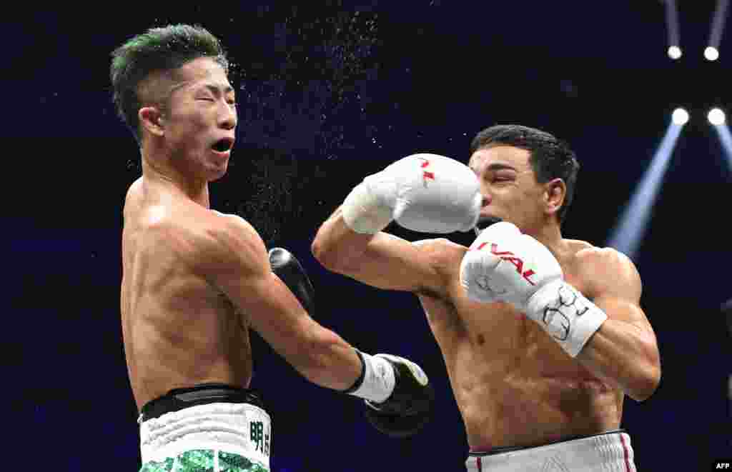 Nordine Oubaali of France (R) fights with of Japan&#39;s Takuma Inoue during their WBC bantamweight title boxing match at Saitama Super Arena in Saitama, Japan.