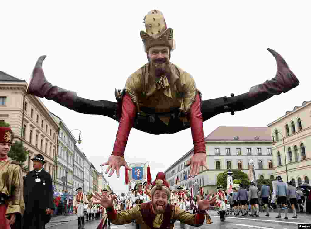 Actors perform during the Oktoberfest parade in Munich, Germany.