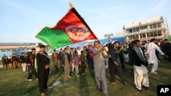 FILE: Afghan cricket fans celebrate the victory of the national cricket team over Zimbabwe as the team returns and celebrates in Kabul, Afghanistan.