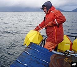 Prince William Sound Science Center's Scott Pegau deploys an acoustic receiver for a new POST line in Port Gravina, Alaska.