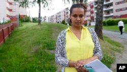 Hiwet Tesfamariam Berhe holds photocopies of documents she told the Associated Press belong to her brother Medhane Tesfamariam Berhe, in Oslo, June 9, 2016. Berhe said that her brother was misidentified as Medhane Yehdego Mered, an Eritrean man accused of trafficking thousands of Africans to Italy.