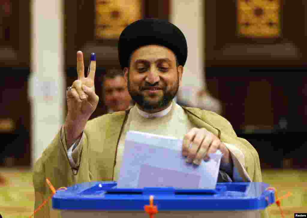 Ammar al-Hakim, leader of the Islamic Supreme Council of Iraq, shows his ink-stained finger as he casts his ballot during parliamentary election in Baghdad April 30, 2014. Iraqis head to the polls on Wednesday in their first national election since U.S. f