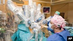 FILE - Surgeons use the robot da Vinci to aid a hernia operation, at the University Hospital Geneva, in Geneva, Switzerland, Nov. 13, 2008. 