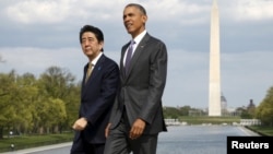 FILE - U.S. President Barack Obama and Japanese Prime Minister Shinzo Abe visit the Lincoln Memorial in Washington, with Washington Monument in the background, April 27, 2015.