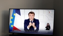 French President Emmanuel Macron is seen on a TV screen as he addresses the nation about the state of the coronavirus disease (COVID-19) outbreak as a fast-spreading third wave of COVID-19 infections threatens to over-run hospitals in France, March 31, 20