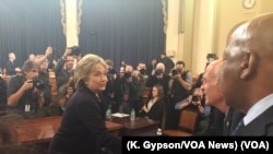 Former U.S. Secretary of State Hillary Clinton greets people following her morning testimony before the House Select Committee on Benghazi on Capitol Hill, Oct. 22, 2015.