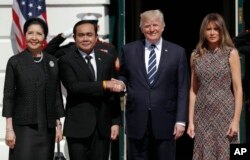 President Donald Trump and first lady Melania Trump greet Thailand's Prime Minister Prayuth Chan-ocha, and his wife Naraporn Chan-ocha at the White House in Washington, Oct. 2, 2017.