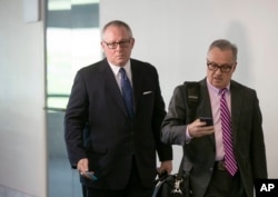 FILE - Former Donald Trump campaign official Michael Caputo, left, joined by his attorney Dennis C. Vacco, leaves after being interviewed by Senate Intelligence Committee staff investigating Russian meddling in the 2016 presidential election, on Capitol Hill in Washington, May 1, 2018.