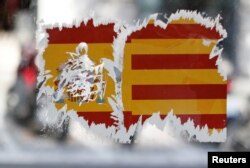 A defaced pro-union sticker is seen on a bus stop in Barcelona, Spain, Oct. 9, 2017.