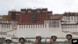 People's Armed Police officers patrol in front of the Potala Palace