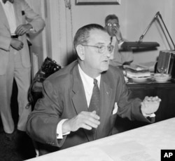 FILE - In this July 30, 1954, file photo, then-Sen. Lyndon Johnson, D-Texas, holds a news conference in Washington. The amendment named for him is a provision in the U.S. tax code that prohibits all 501(c)(3) nonprofits from endorsing or opposing political candidates.