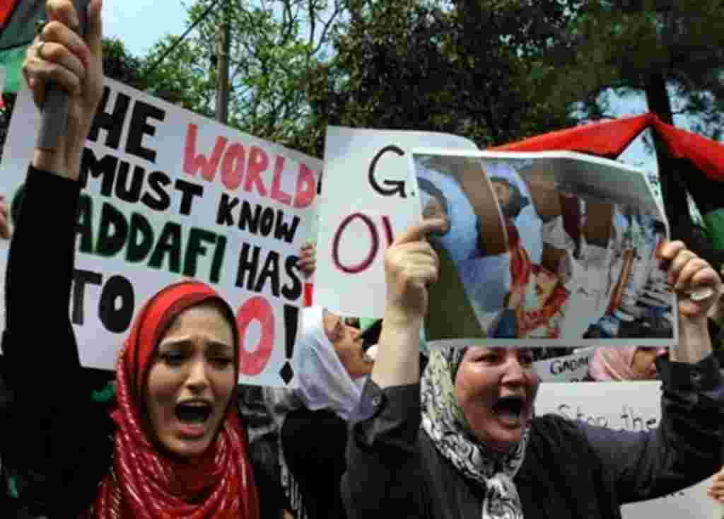 Libyan protesters shout slogans against Libyan leader Gadhafi in front of the Libyan embassy in Kuala Lumpur on February 23, 2011.