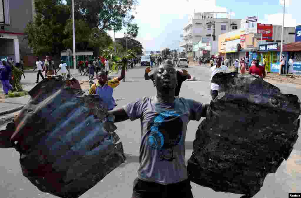 A man celebrates in a street in Bujumbura, Burundi, May 13, 2015.