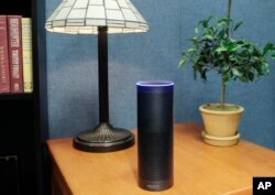 FILE - Amazon's Echo, an Alexa-compatible digital assistant that continually listens for commands such as for a song, a sports score or the weather, is pictured in New York, July 29, 2015.