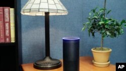 FILE - Amazon's Echo, an Alexa-compatible digital assistant that continually listens for commands such as for a song, a sports score or the weather, is pictured in New York, July 29, 2015.