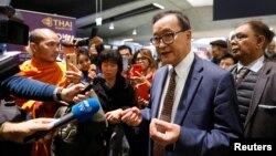 Cambodia's self-exiled opposition party founder Sam Rainsy, who has vowed to return to his home country, talks to supporters after being prevented from checking-in for a flight from Paris to Bangkok at Roissy Airport in Paris, France November 7, 2019. 