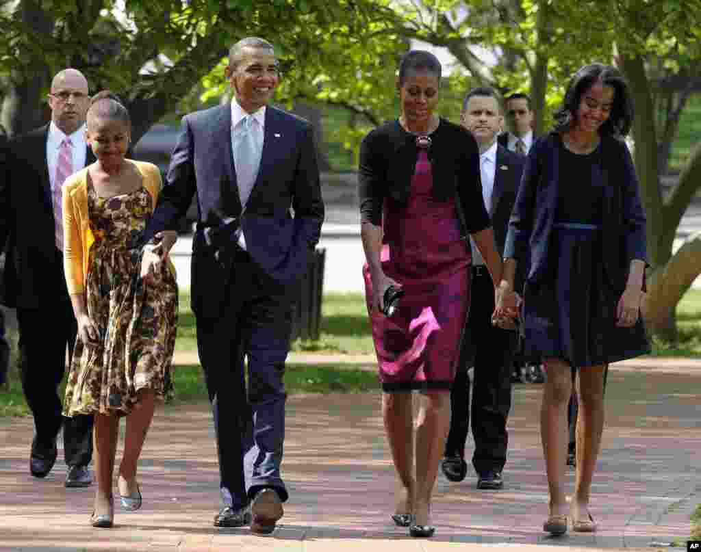 President Barack Obama, first lady Michelle Obama, daughters Malia, right, and Sasha walk from the White House to St. John's Episcopal Church for Easter service in Washington Sunday, April 8, 2012.