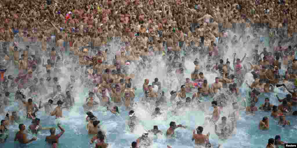 People dance in a pool party during the gay and lesbian Circuit Festival in Vilassar de Dalt, near Barcelona, Spain.