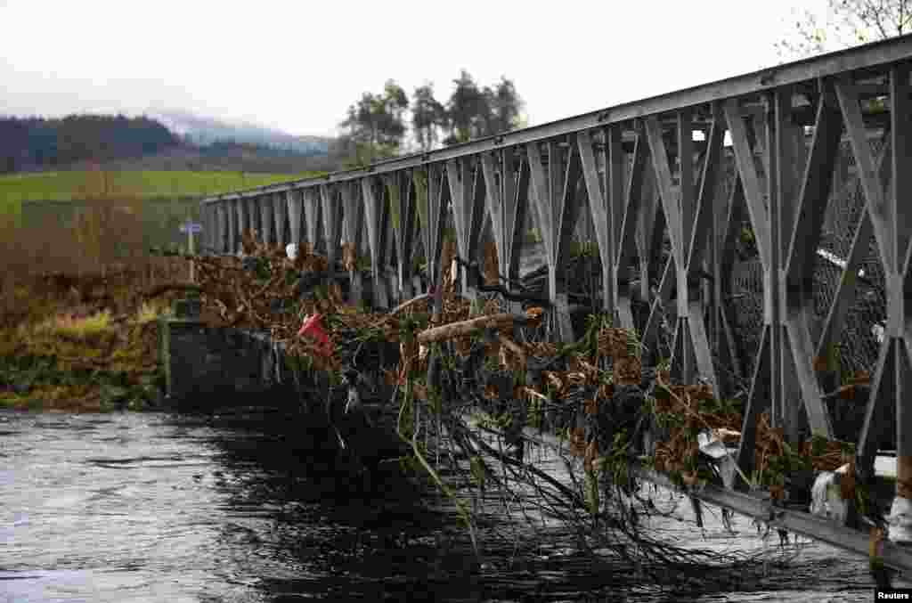 A footbridge is littered with debris following flooding at Newton Stewart in Scotland, Britain. Torrential rain and gale force winds have battered northern Britain cutting power to thousands of homes and forcing some to evacuate flooded streets in the third major storm in a month.