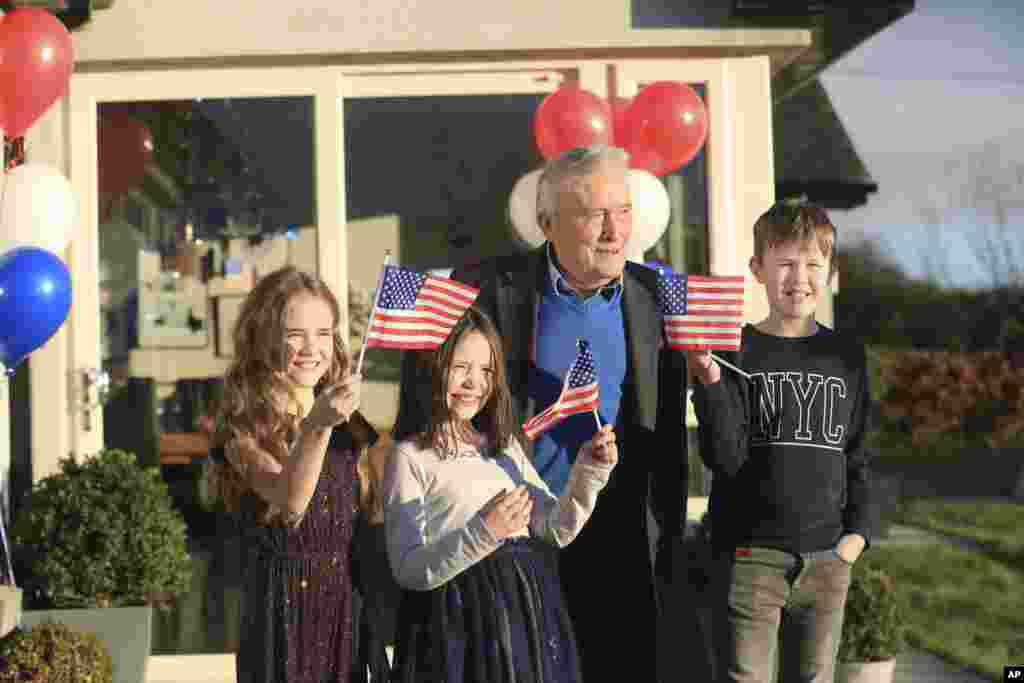 Joe Biden&#39;s cousin Brendan Blewitt with his grandchildren Emily, Lauren, and Darragh wave their U.S. flags to the media from their home in Knockmore, near the town of Ballina in Ireland.